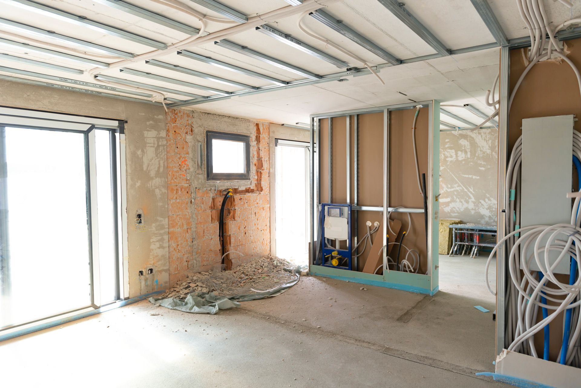 A room that is being remodeled with a sliding glass door.
