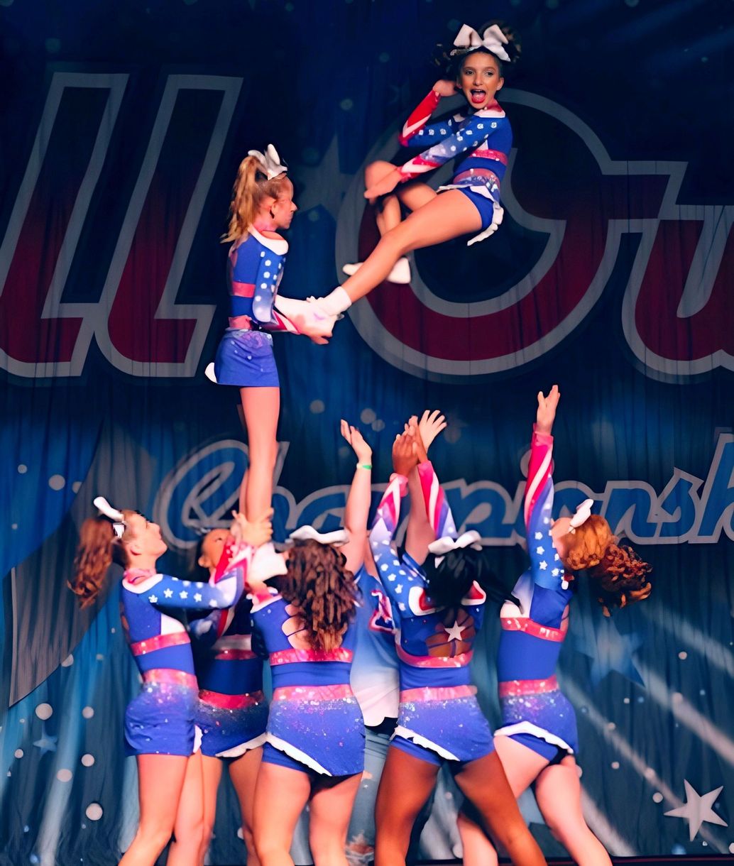 A group of cheerleaders are performing on a stage