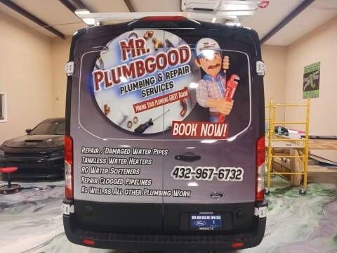 The back of a van that says mr. plumbgood plumbing and repair services