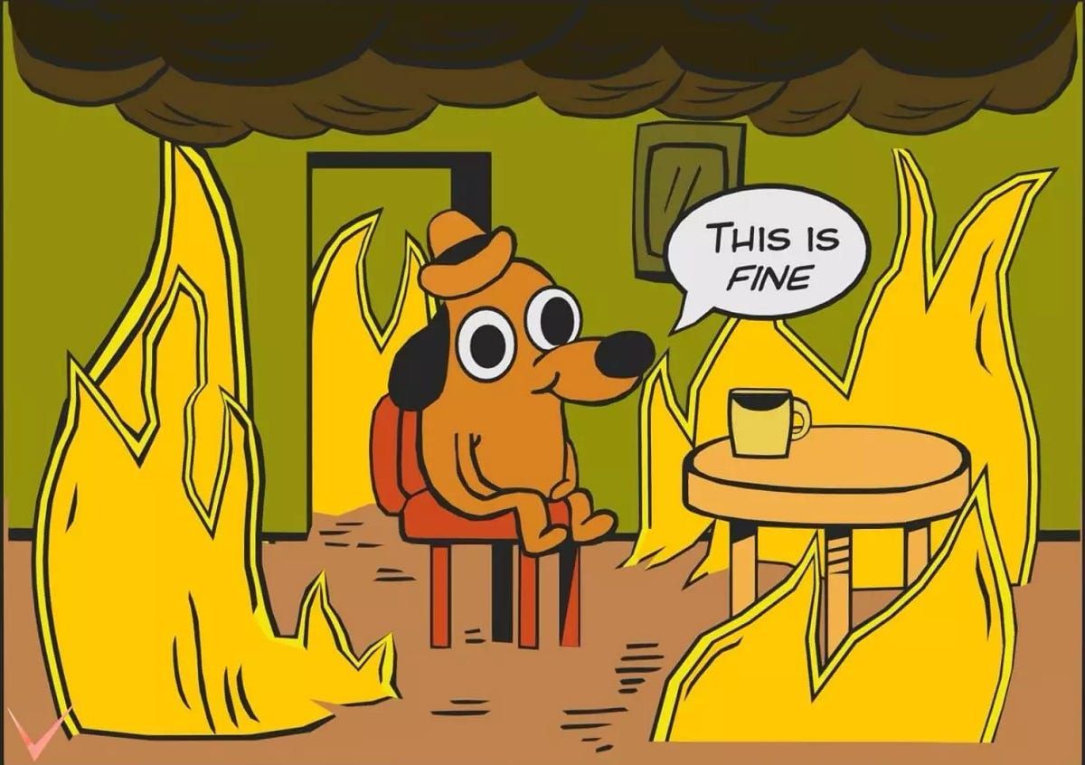 A cartoon dog is sitting at a table with a speech bubble that says this is fine