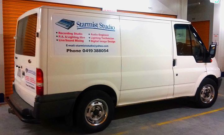 A white van that says ' starmist studio ' on the side