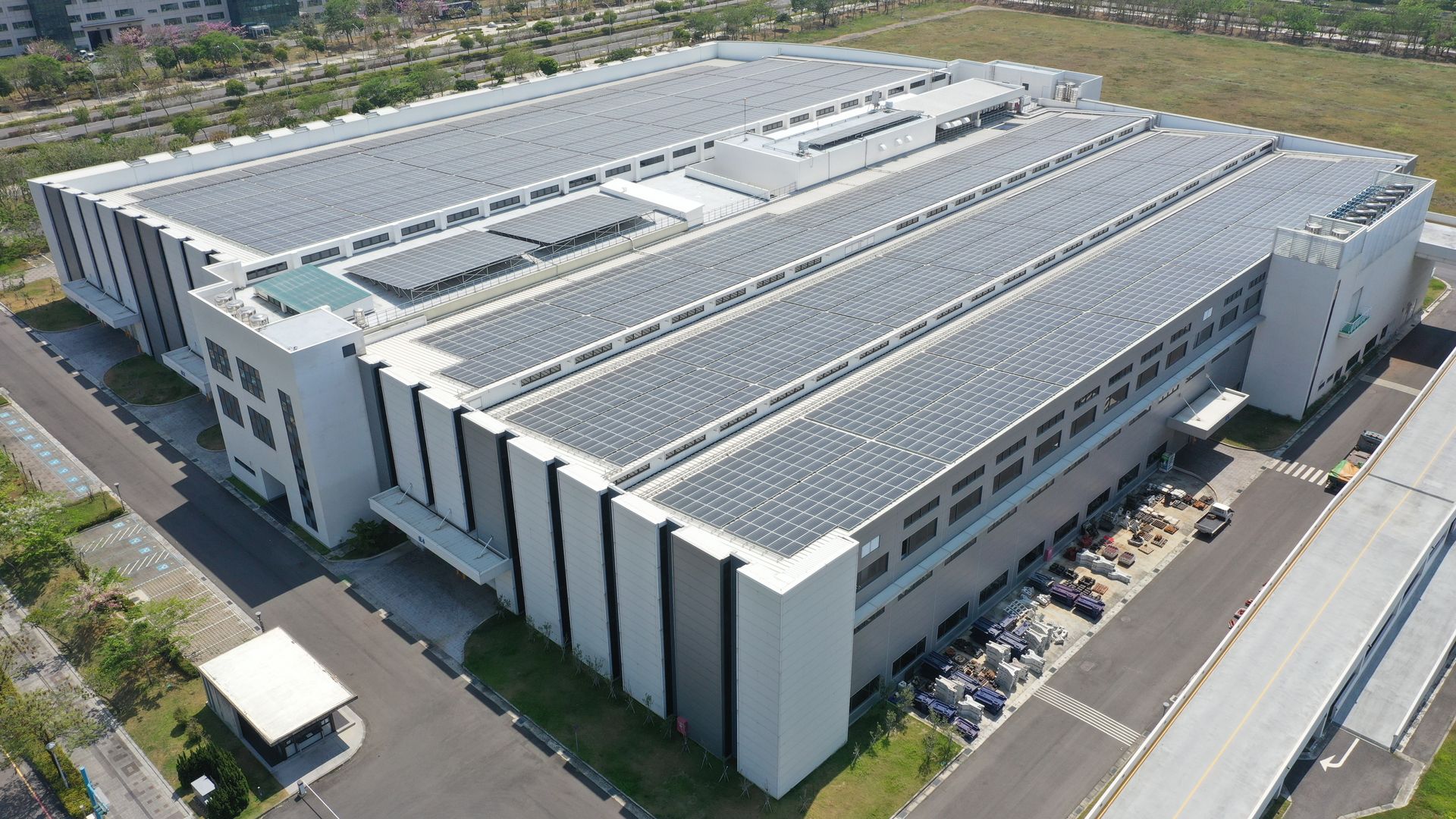 Large industrial building with solar panels on the roof.