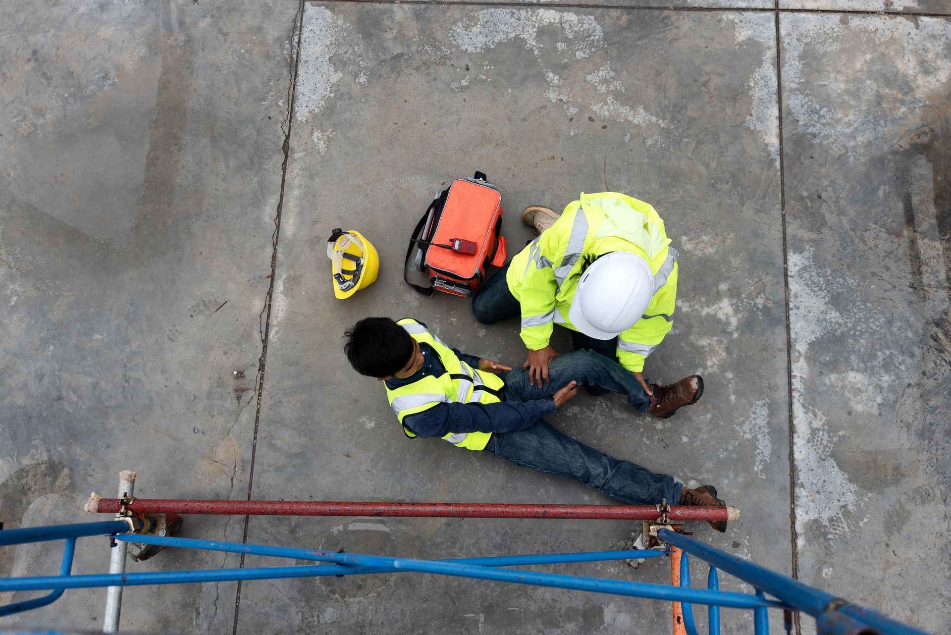 An aerial view of a construction worker laying on the ground.