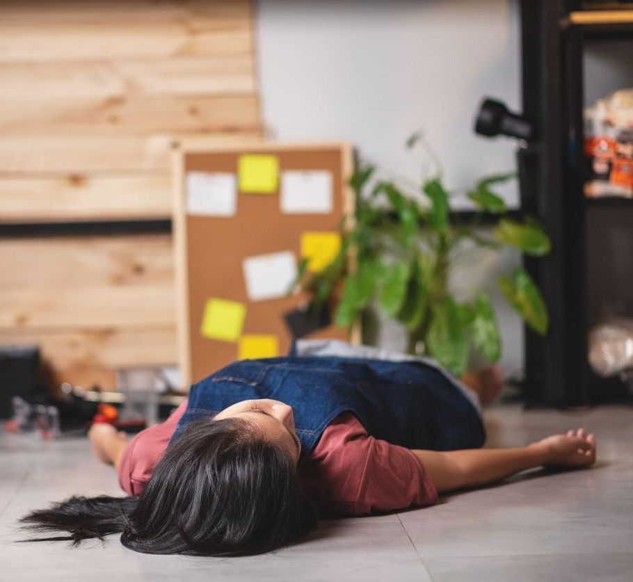 A woman is laying on the floor in a room.