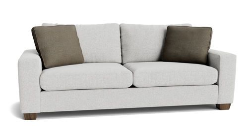 A white couch with brown pillows