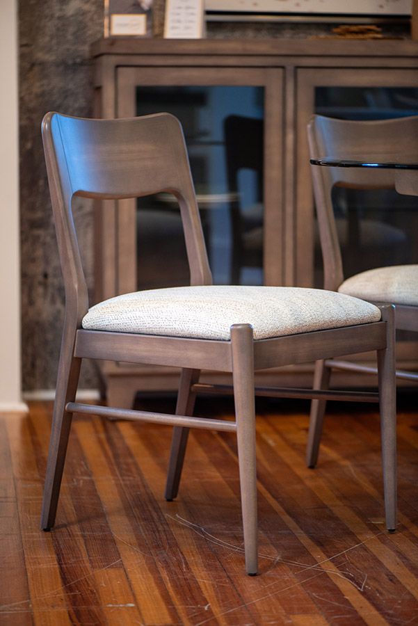 Wooden chair with a light coloured cushion