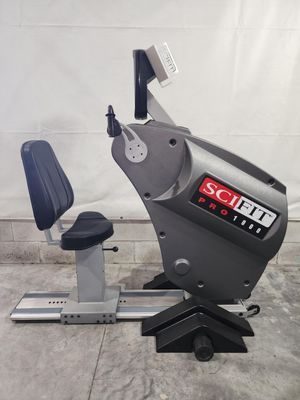 A scifit pro exercise bike is sitting on a concrete floor.
