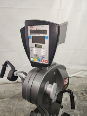 A close up of a exercise bike with a monitor on top of it.