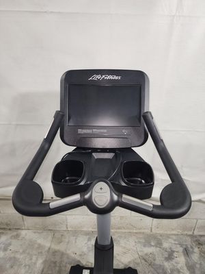 A black exercise bike with a monitor on top of it.