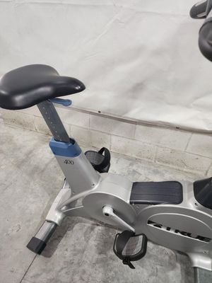 A close up of an exercise bike on a concrete floor.