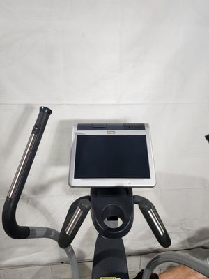 An exercise bike with a tablet on top of it.