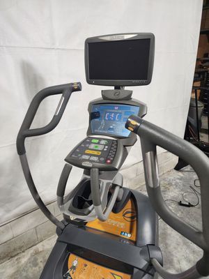 An elliptical machine with a monitor on top of it.