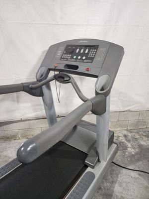 A treadmill is sitting in a garage next to a wall.
