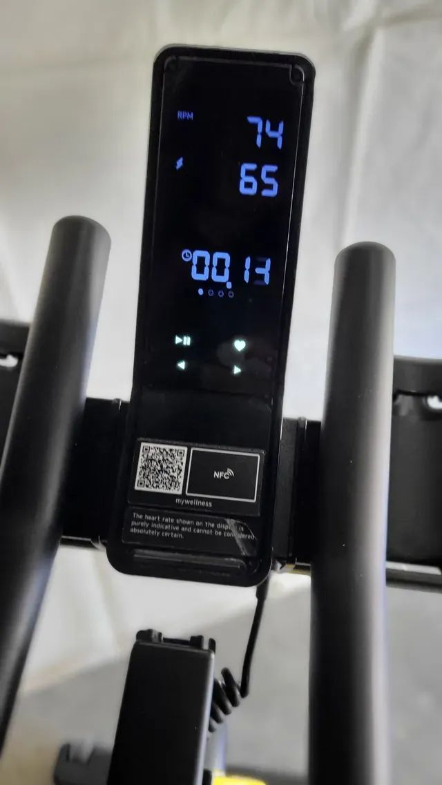 A close up of a remote control on a treadmill.