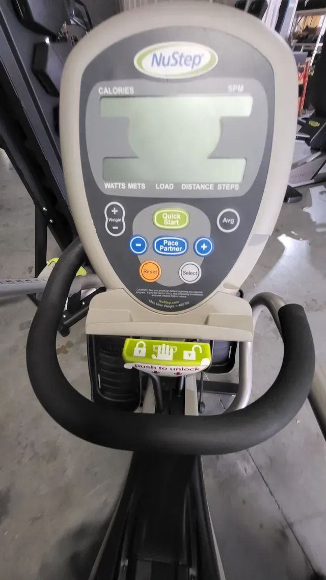 A nustep exercise bike is sitting on a concrete floor.