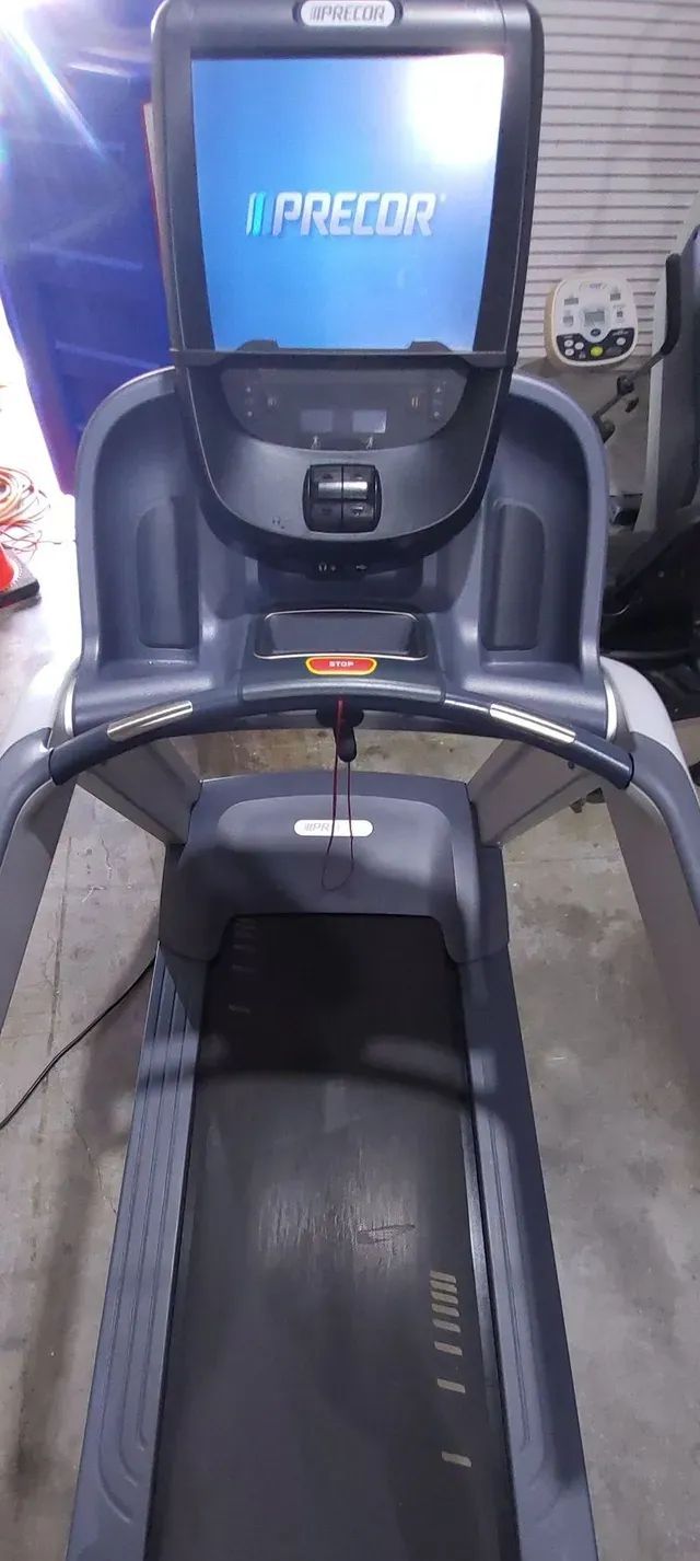 A treadmill with a monitor on top of it.