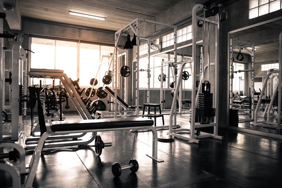 A Gym Filled With Lots of Exercise Equipment and a Bench