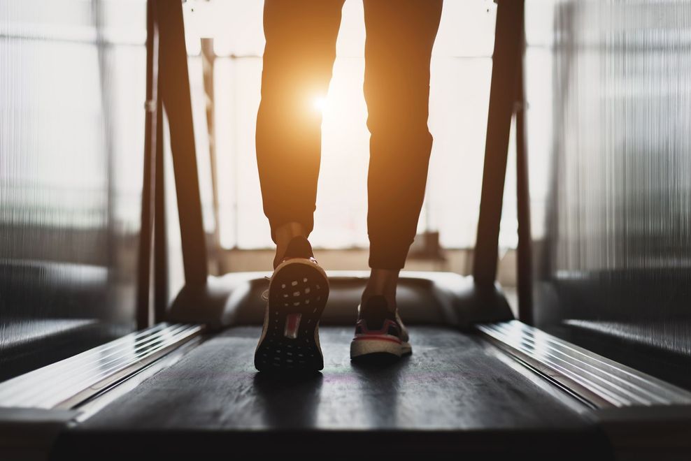A Person is Walking on a Treadmill in a Gym