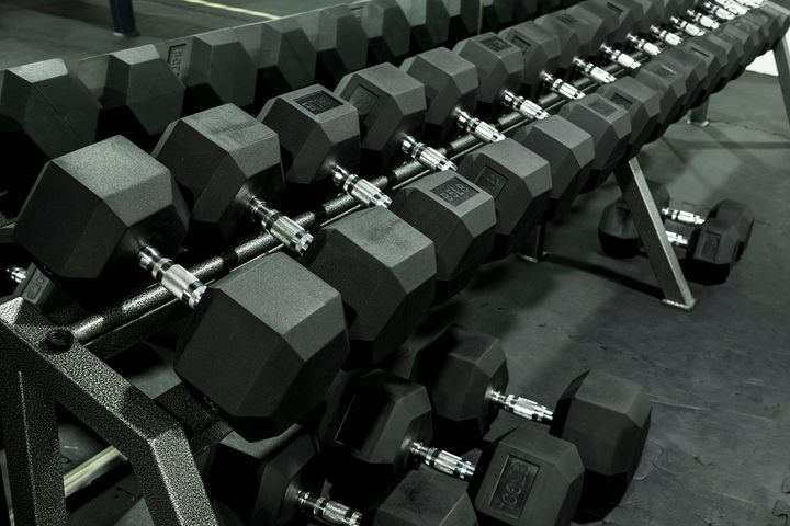 A Row of Black Dumbbells Are Lined Up in a Gym