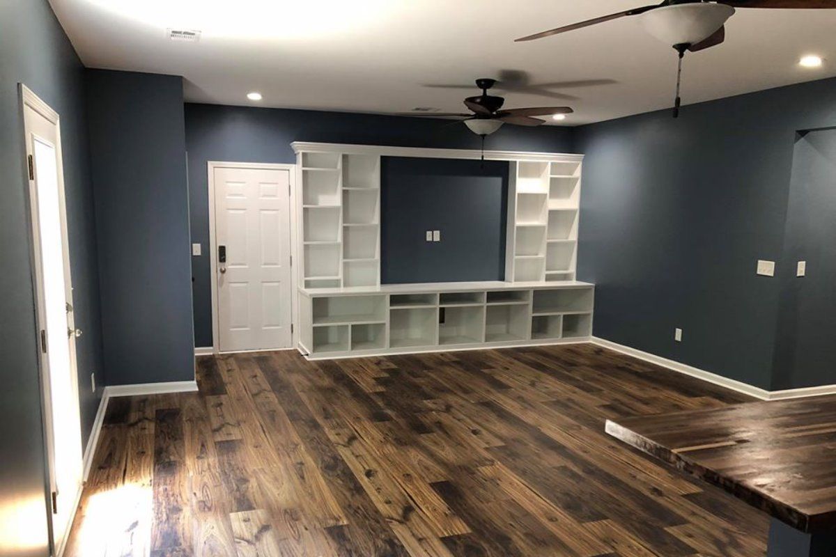 A living room with hardwood floors and a ceiling fan