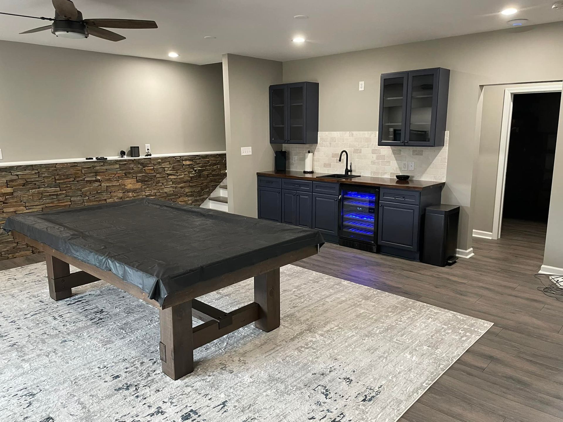 There is a pool table in the middle of the room.