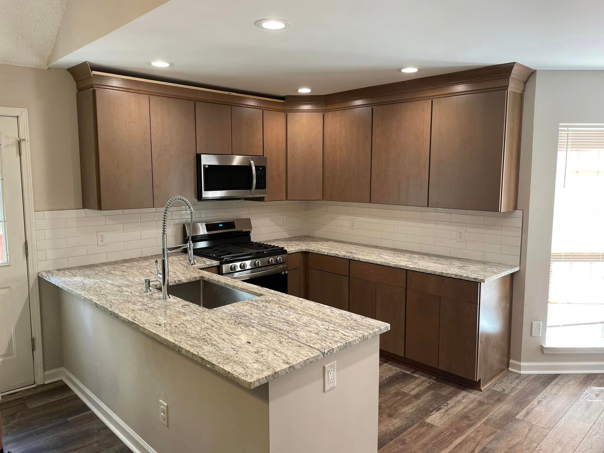 A kitchen with stainless steel appliances and granite counter tops