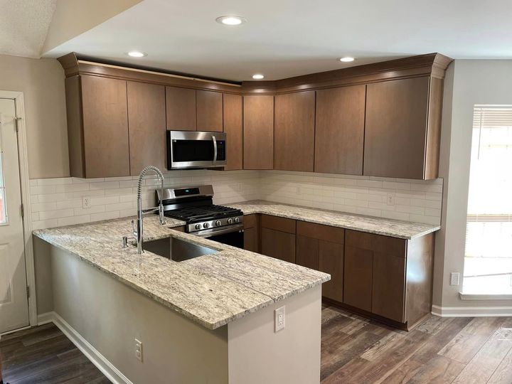 A kitchen with stainless steel appliances and granite counter tops