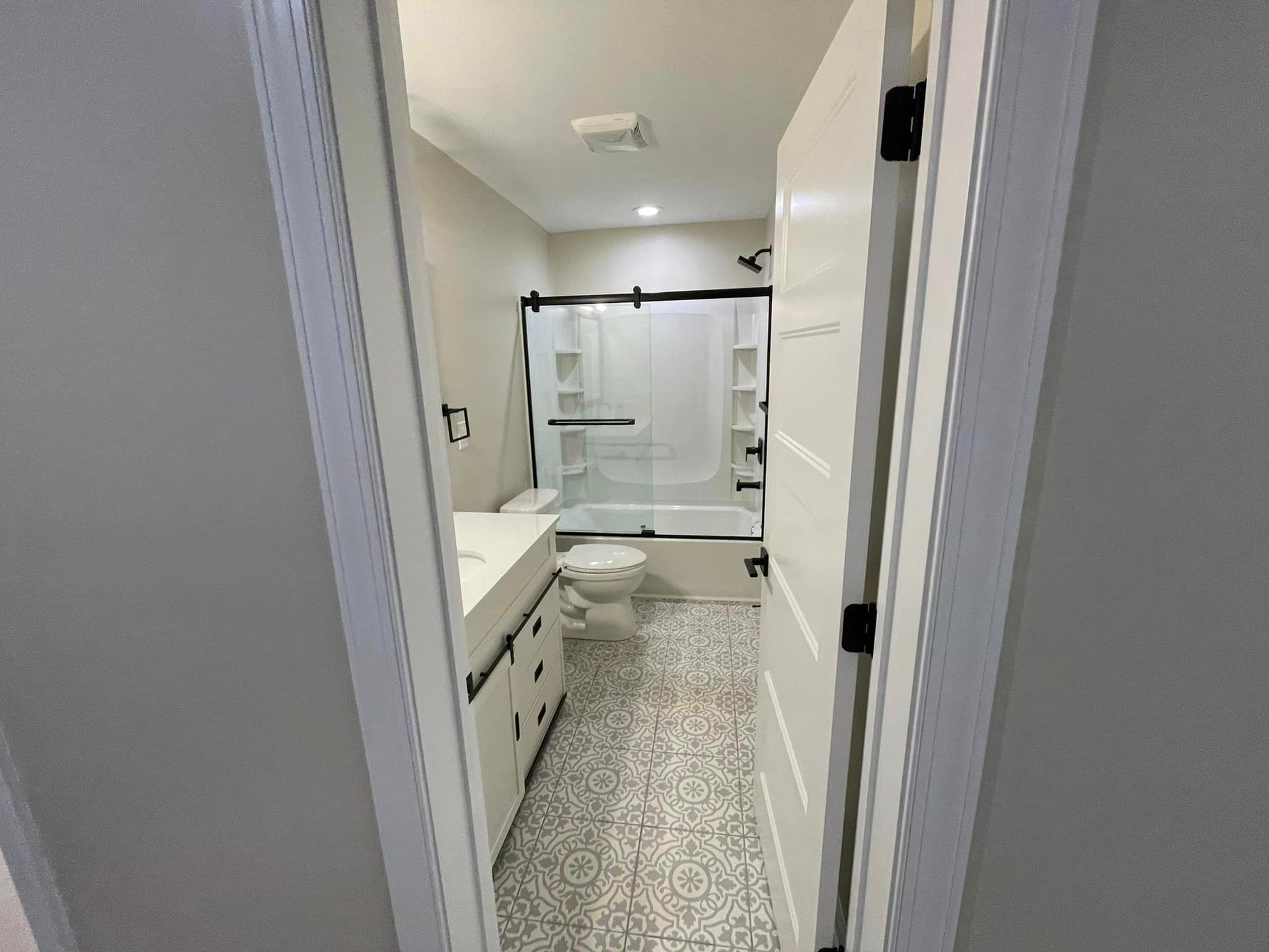 A bathroom with a toilet , sink , tub and shower.