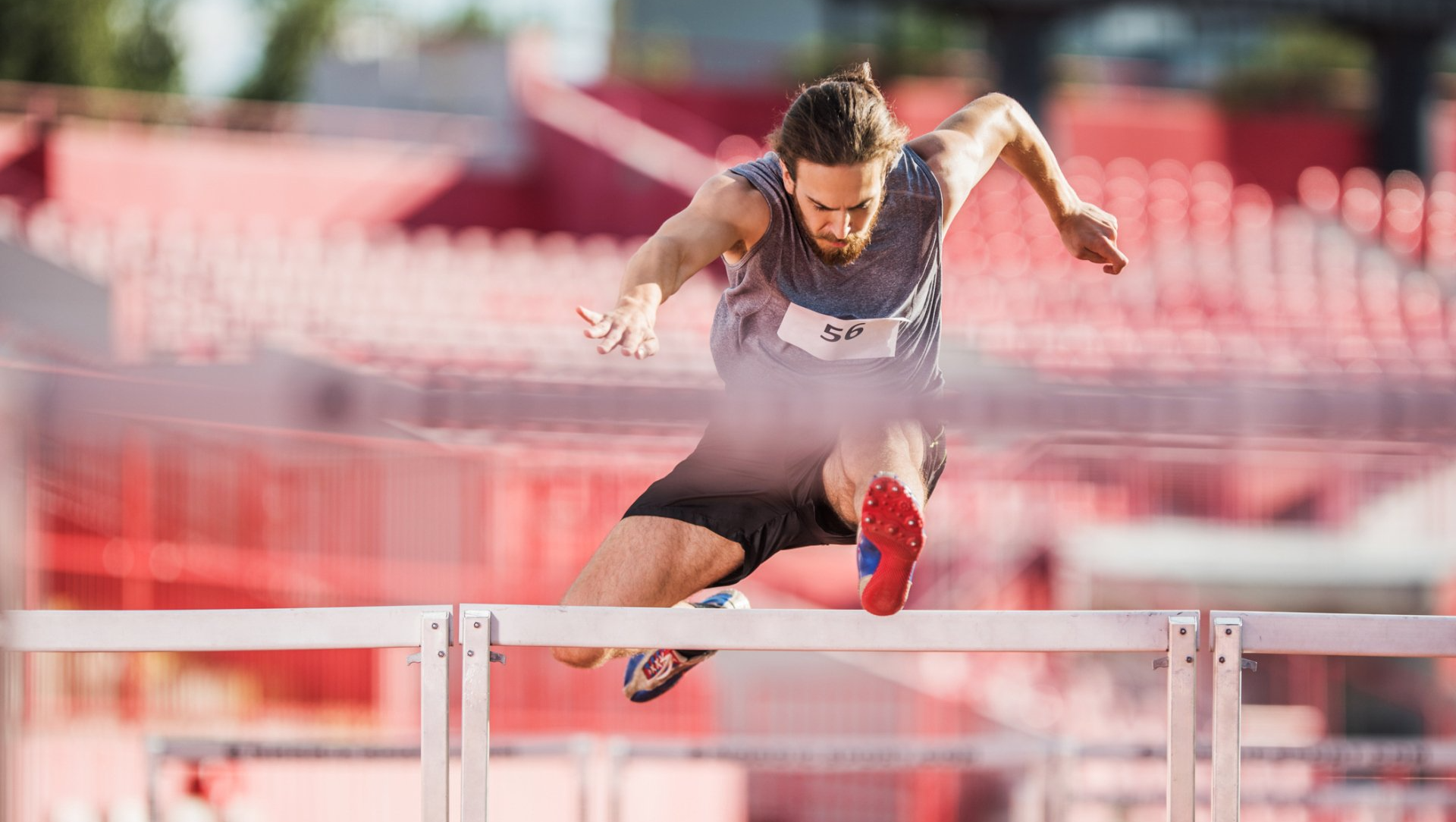 Man jumping over a hurdle