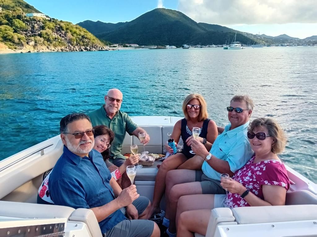 A group of people are sitting on a boat in the water.