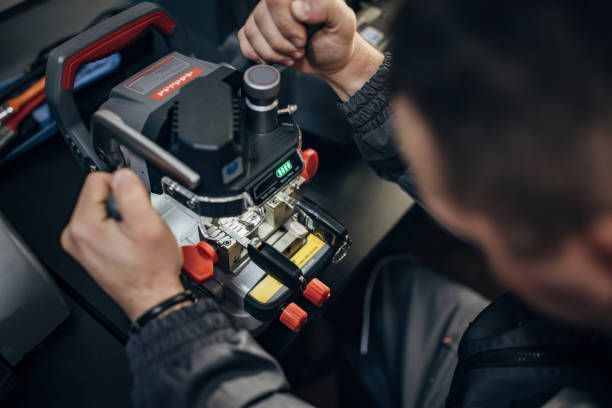 A man is using a machine to make a key.