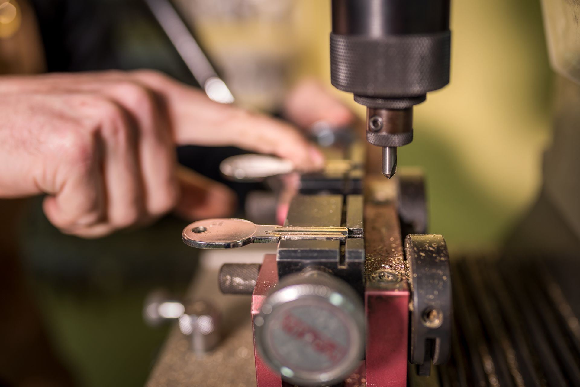 A person is cutting a key with a machine.