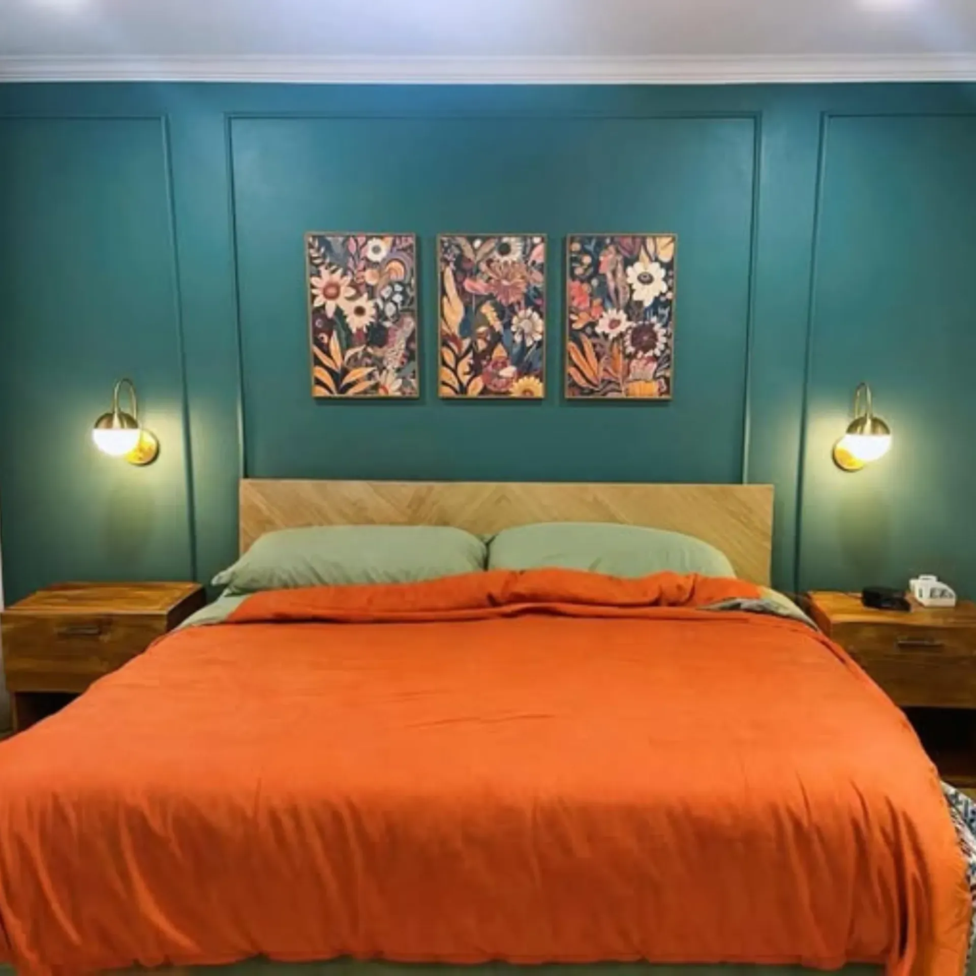 Panther City Electric LLC - A bedroom with a bed and three paintings on the wall