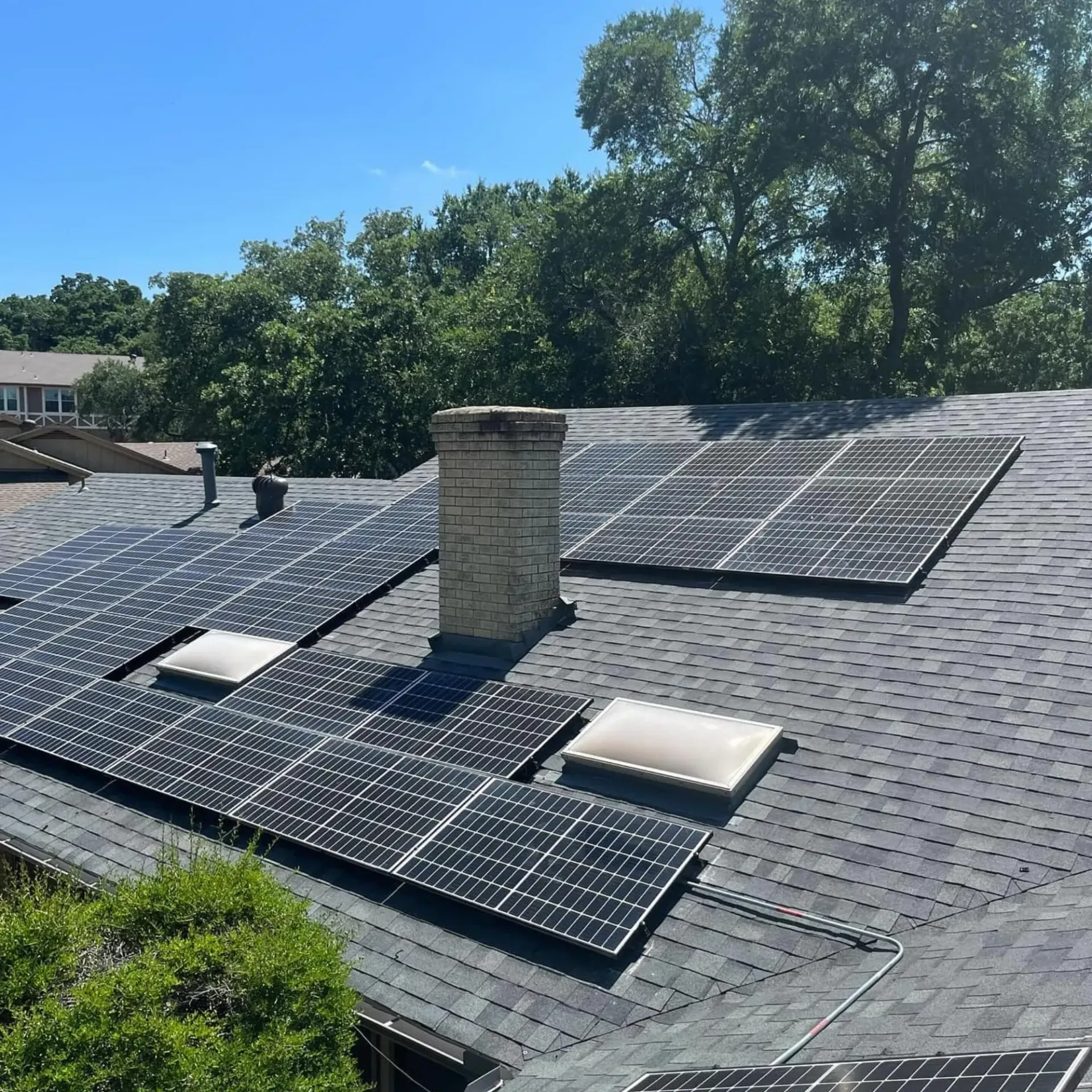 Panther City Electric LLC - A roof with solar panels and a chimney on it