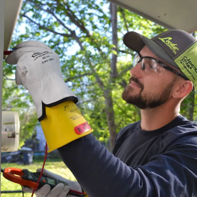 Panther City Electric LLC - A man wearing gloves and a hat that says lakers