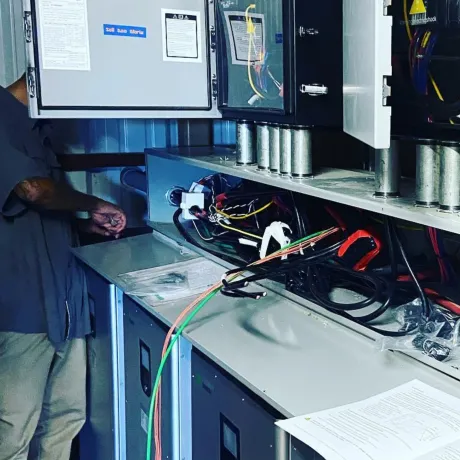 Panther City Electric LLC - A man is working in a room with a lot of wires