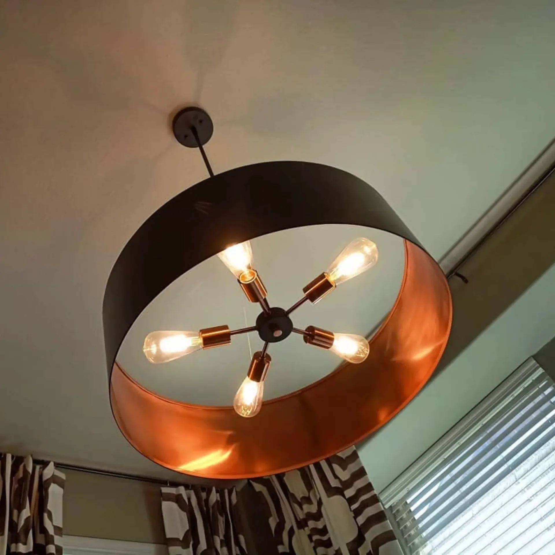 Panther City Electric LLC - A black and copper chandelier is hanging from the ceiling
