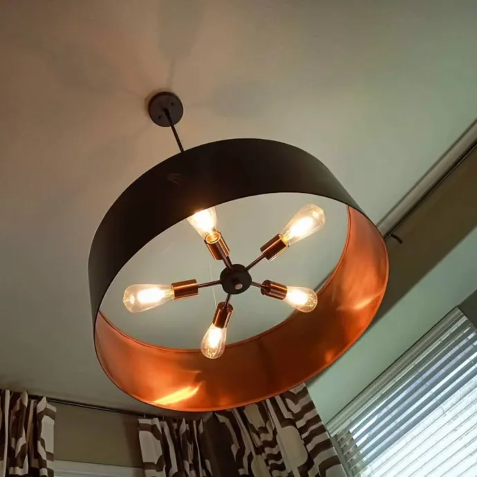 Panther City Electric LLC - A black and copper chandelier is hanging from the ceiling
