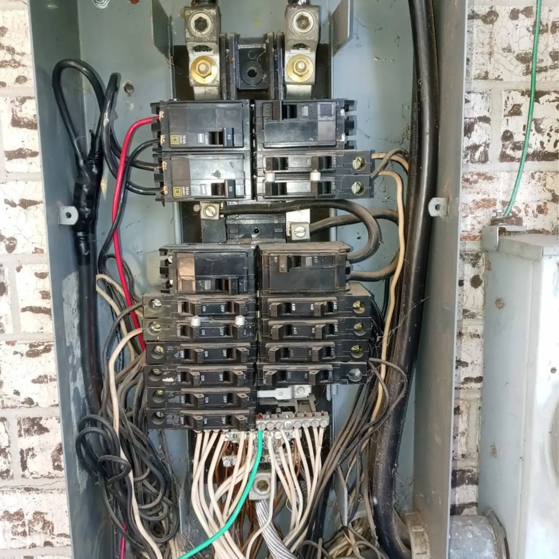 Panther City Electric LLC - A very messy electrical box with a lot of wires coming out of it.