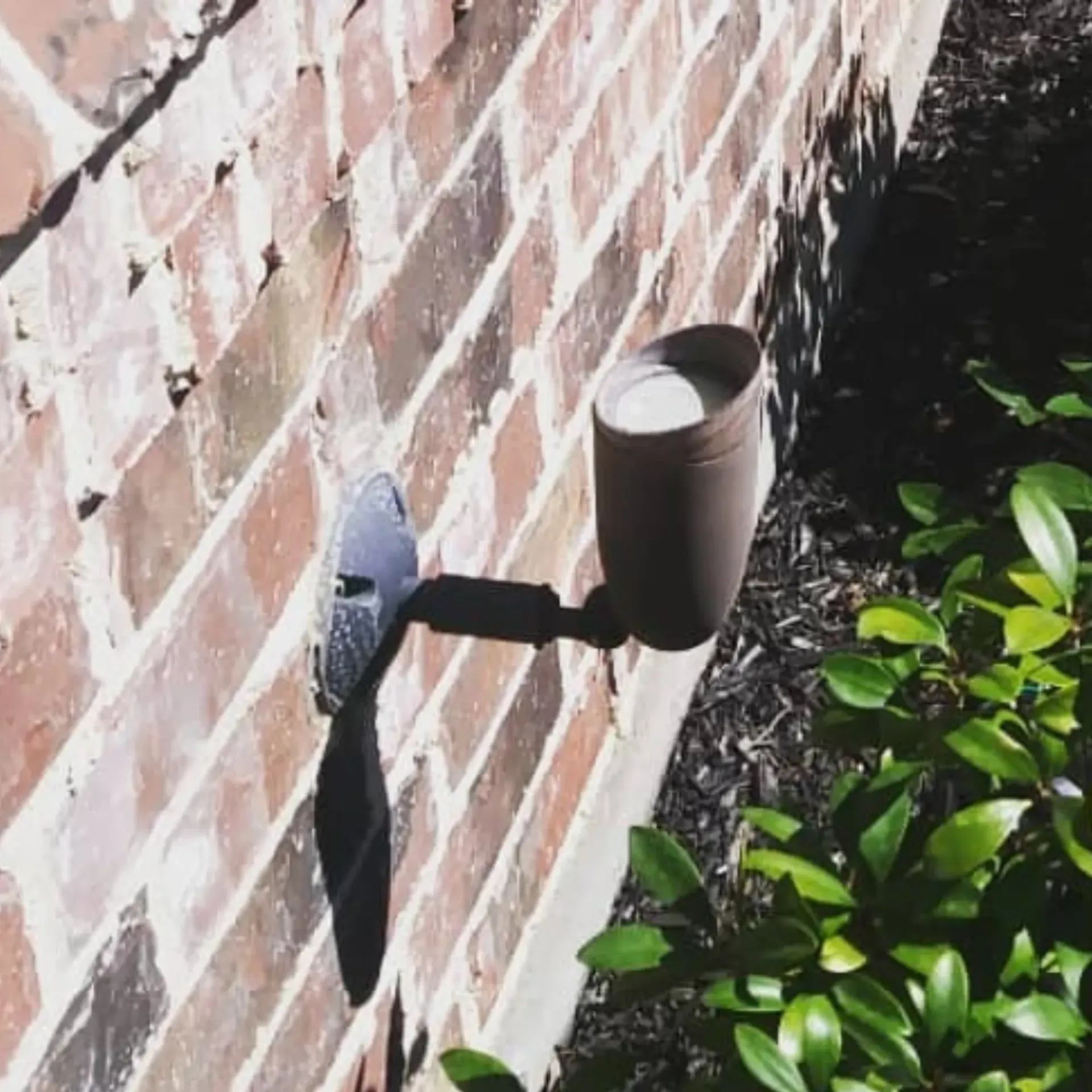 Panther City Electric LLC - A brick wall with a light attached to it