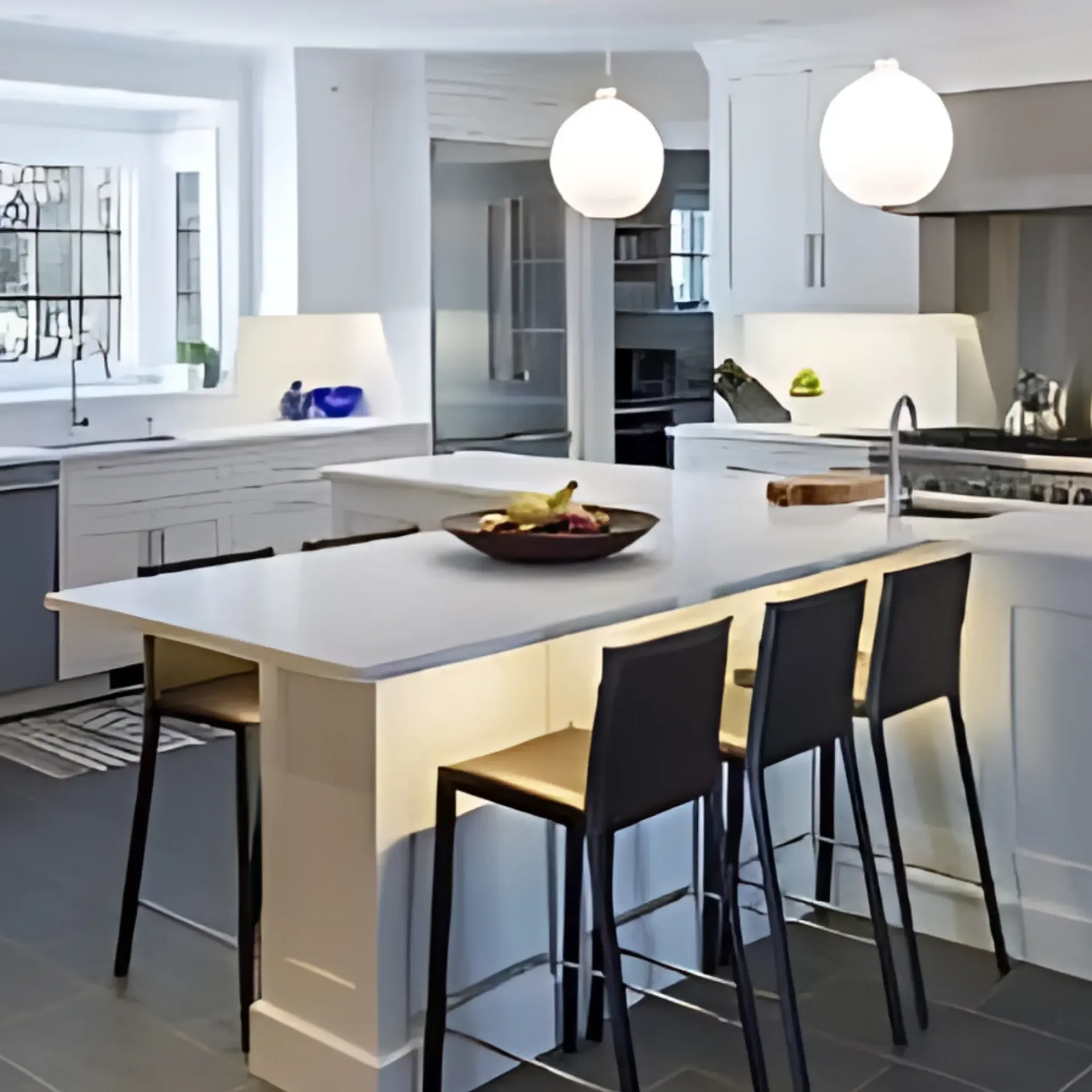 Panther City Electric LLC - A kitchen with a large island with a bowl of fruit on it