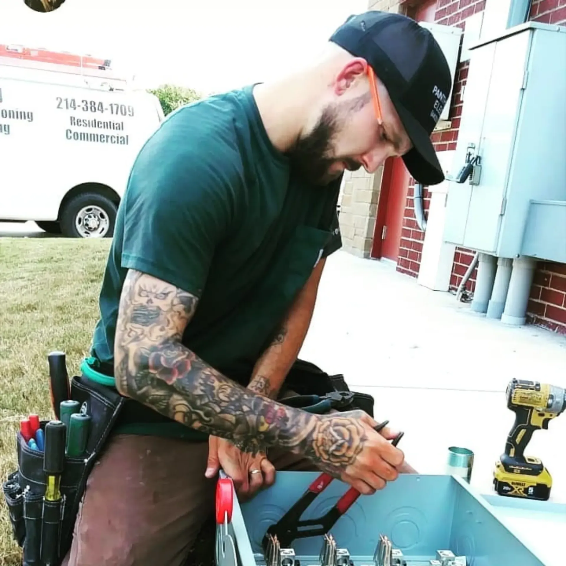 Panther City Electric LLC - A man in a green shirt is working on a box