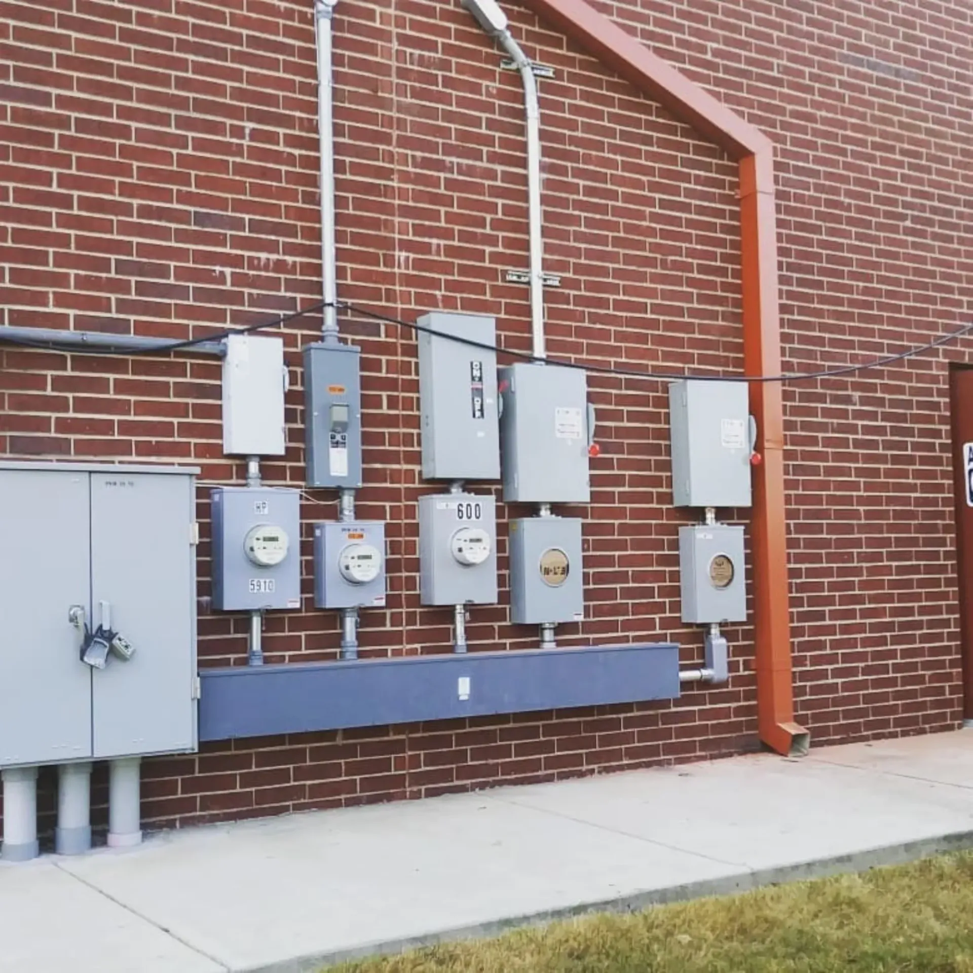 Panther City Electric LLC - A brick wall with a bunch of electrical boxes on it