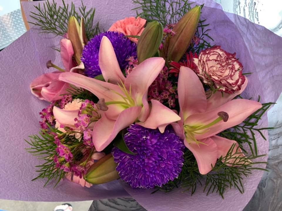 A Bouquet Of Pink And Purple Flowers Wrapped In Purple Paper โ The House of Flowers In Kirwan, QLD