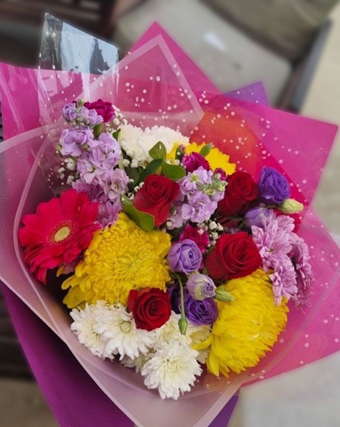A Bouquet Of Pink And Purple Flowers Wrapped In Purple Paper — The House of Flowers In Kirwan, QLD