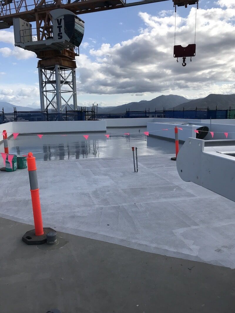 A Large Crane Is Sitting On Top Of A Building Under Construction — Eldred Waterproofing In Whitfield, QLD