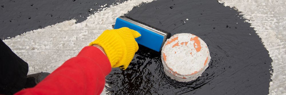 A Person Wearing Yellow Gloves Is Using A Sponge — Eldred Waterproofing In Whitfield, QLD