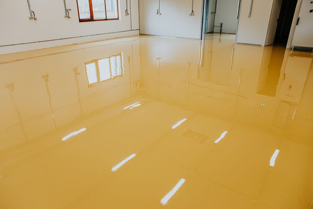 A Room With A Yellow Epoxy Floor And A Lot Of Windows — Eldred Waterproofing In Whitfield, QLD