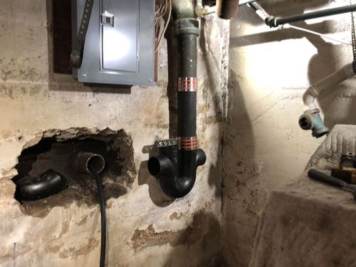 There is a hole in the wall in the corner of the room.