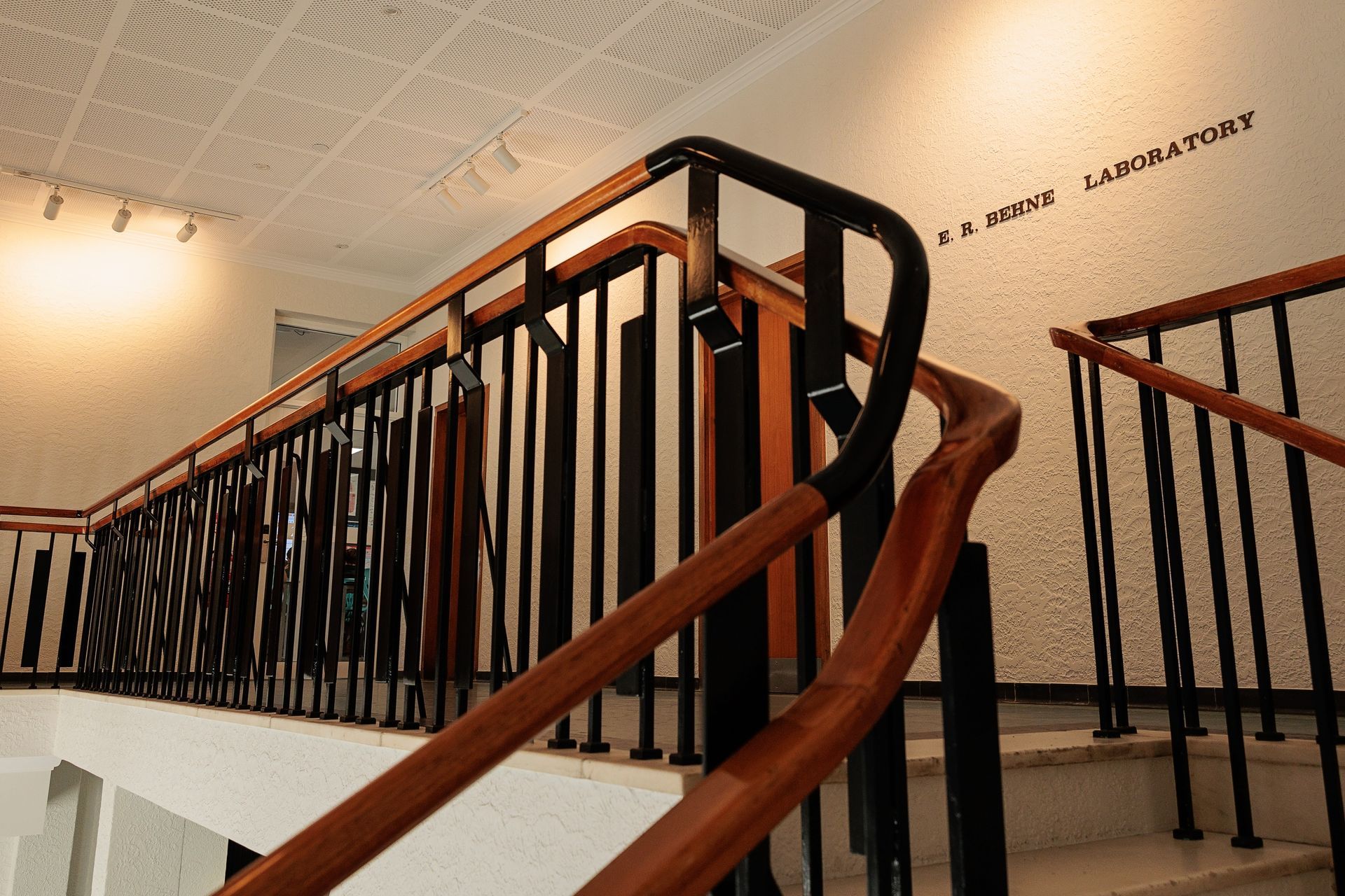 Staircase With Black Metal Railing and Wooden Handrails, Leading Upwards — BOLD Architecture + Interior Design In Mackay, QLD